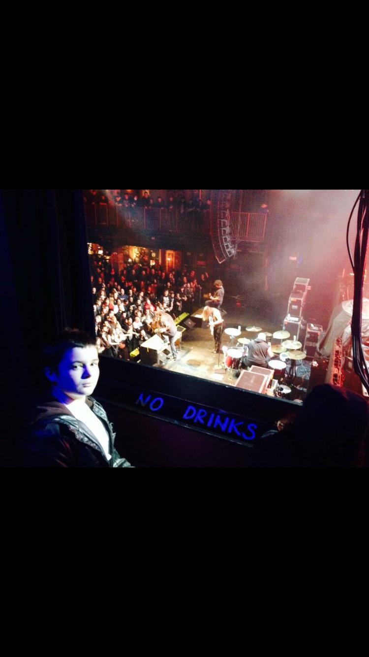 Live music and performance photo with artists, crew, and event guests.