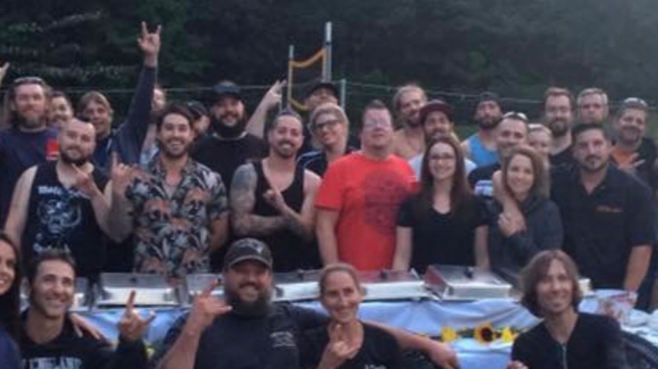 Live music and performance photo with artists, crew, and event guests.