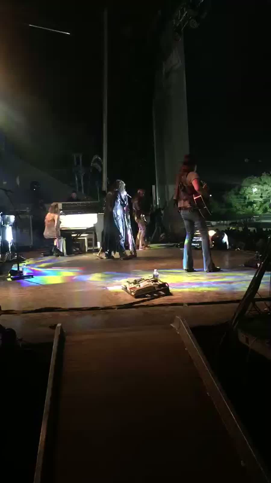 Live music and performance photo with artists, crew, and event guests.