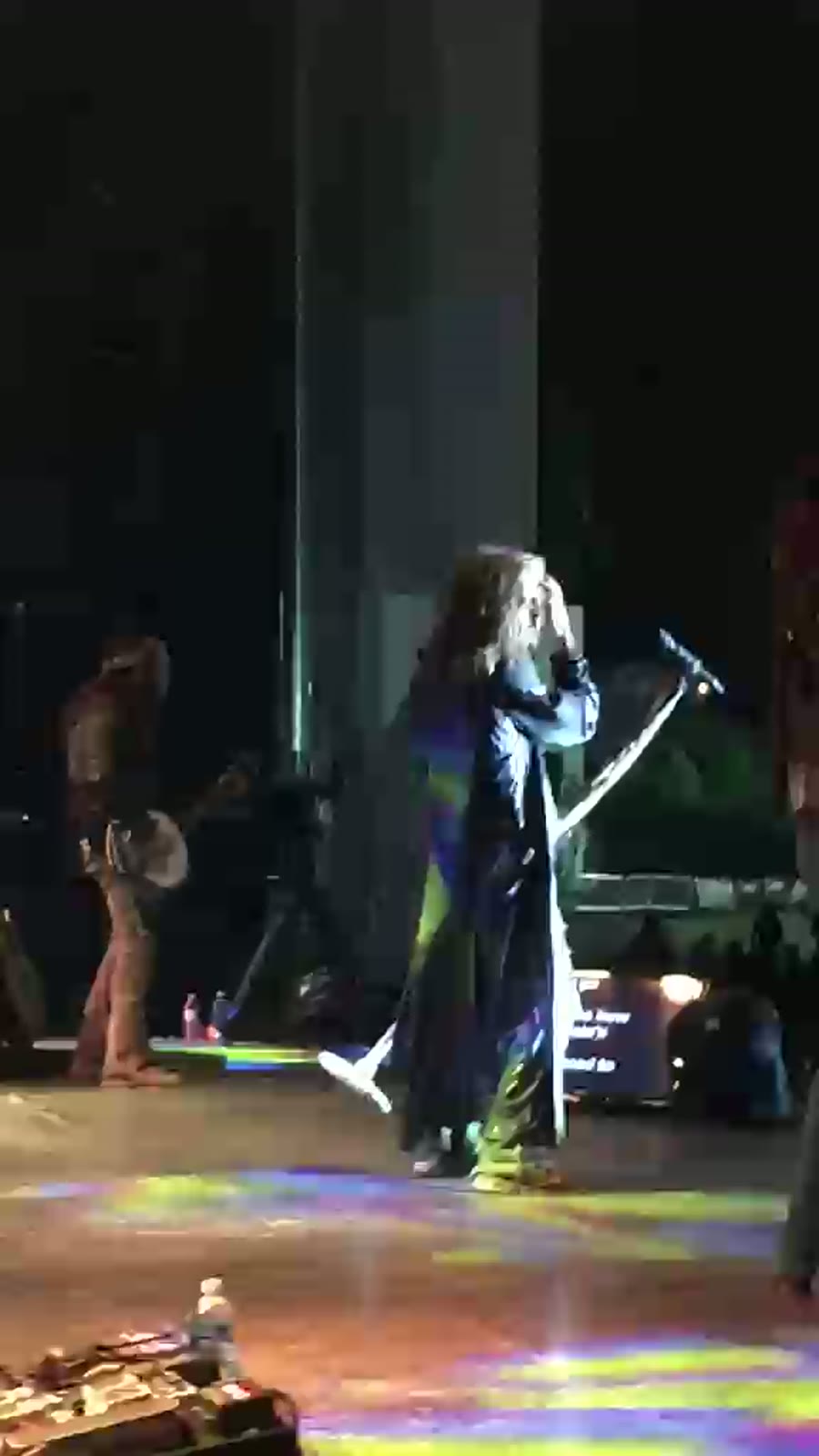Live music and performance photo with artists, crew, and event guests.