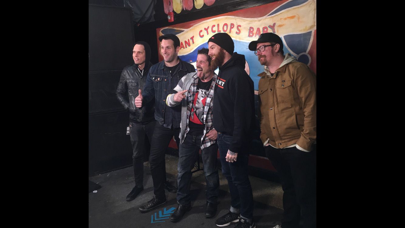 Live music and performance photo with artists, crew, and event guests.