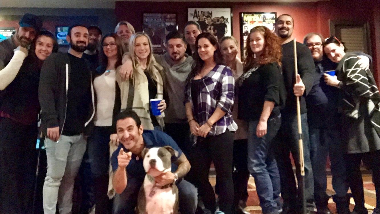 Live music and performance photo with artists, crew, and event guests.